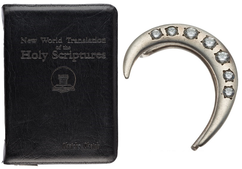 Prince's personal travel bible, and his white zirconium-studded ear cuff 