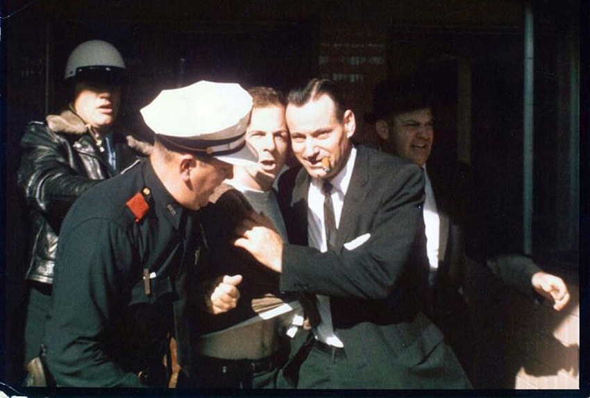 Lee Harvey Oswald being led from the Texas Theatre, following his arrest for the murder of officer J.D Tippet