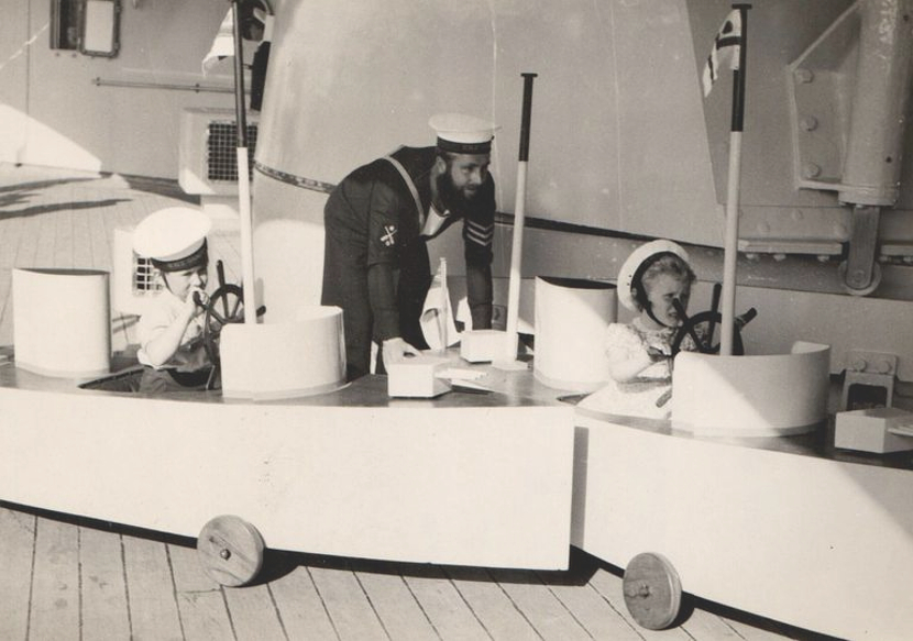 Prince Charles and Princess Anne as young children playing in toy boats