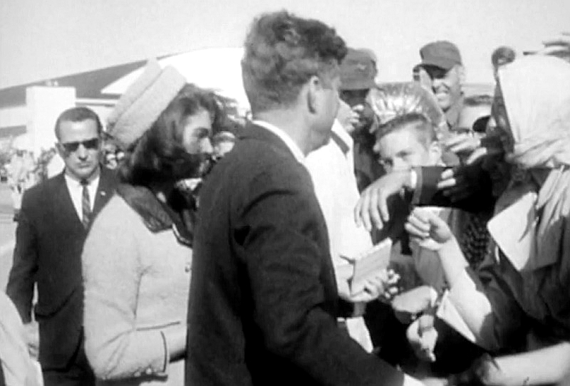 Archive film footage shows Kennedy being handed the notebook to sign by a member of the crowd.