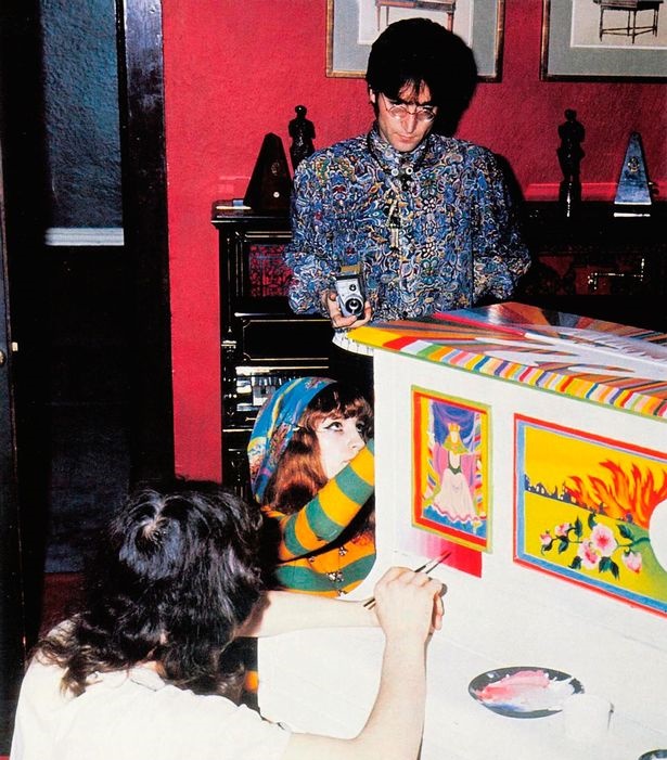 Lennon at his Kenwood home in 1967, with the Sgt Pepper piano seen behind him.