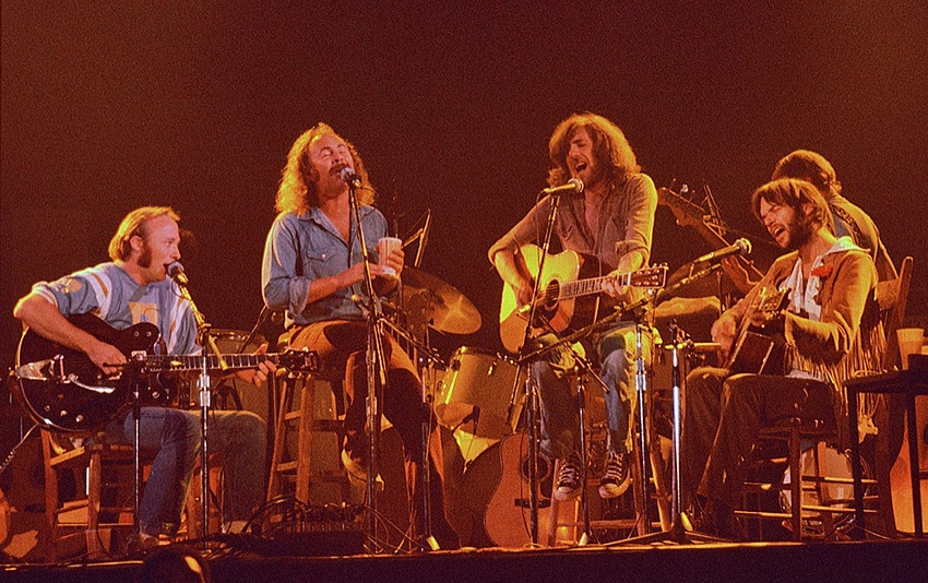 Graham Nash (third right), playing his Martin accoustic guitar at the Woodstock Festival in 1969 