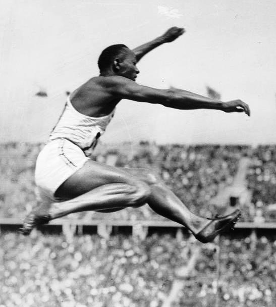 Jesse Owens photographed on his way to victory in the long-jump at the 1936 Berlin Olympic games.
