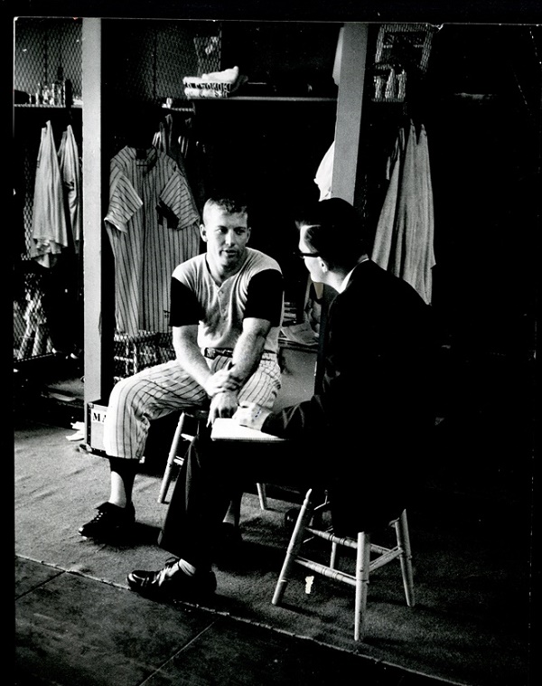 Mantle's jersey can be seen hanging in his locker behind him, in this famous photograph from the 1956 season (Image: Mile High Card Company)