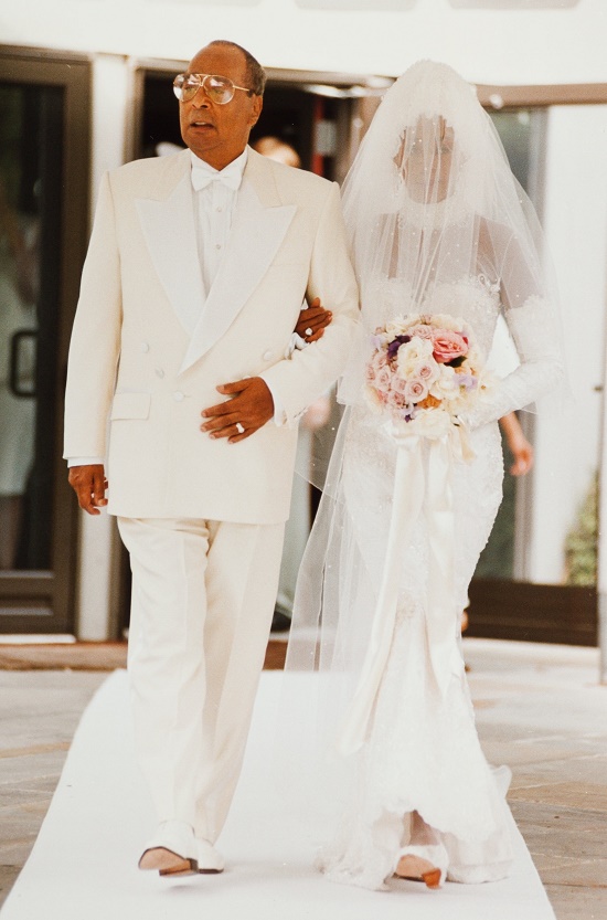 Whitney Houston walks down the aisle with her father John Houston, during her wedding to Bobby Brown on July 18, 1992 (Image: Heritage Auctions)