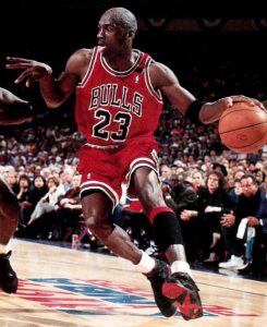 Michael Jordan playing basketball in his famous 23 Chicago Bulls shirt