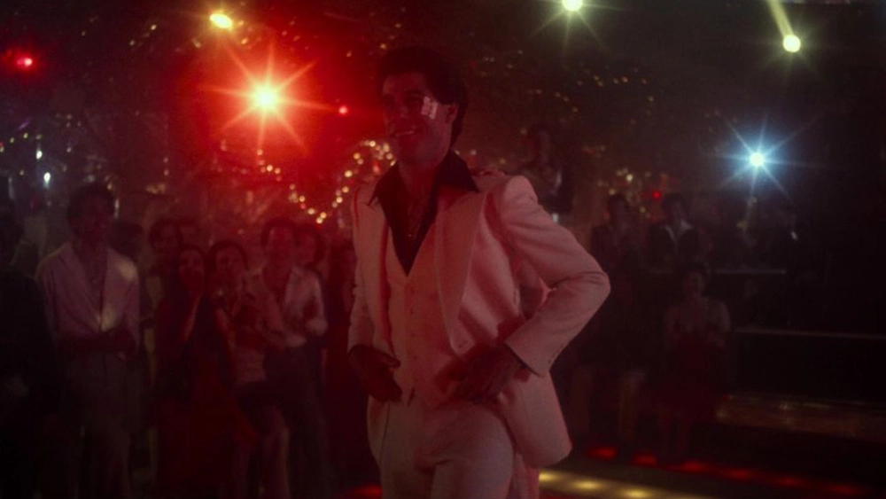 John Travolta in a white, 3-piece suit in Saturday Night Fever.