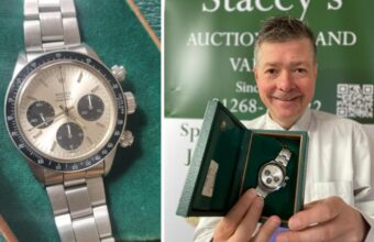 Auctioneer Mark Stacey poses with a Rolex Cosmograph Daytona sold for £45,000 in Essex.