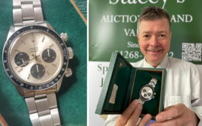 Auctioneer Mark Stacey poses with a Rolex Cosmograph Daytona sold for £45,000 in Essex.