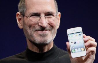 A portrait of Steve Jobs holding an Apple iPhone 4 in 2010.