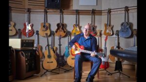 Mark Knolfler with his guitars, which are to be sold at auction.