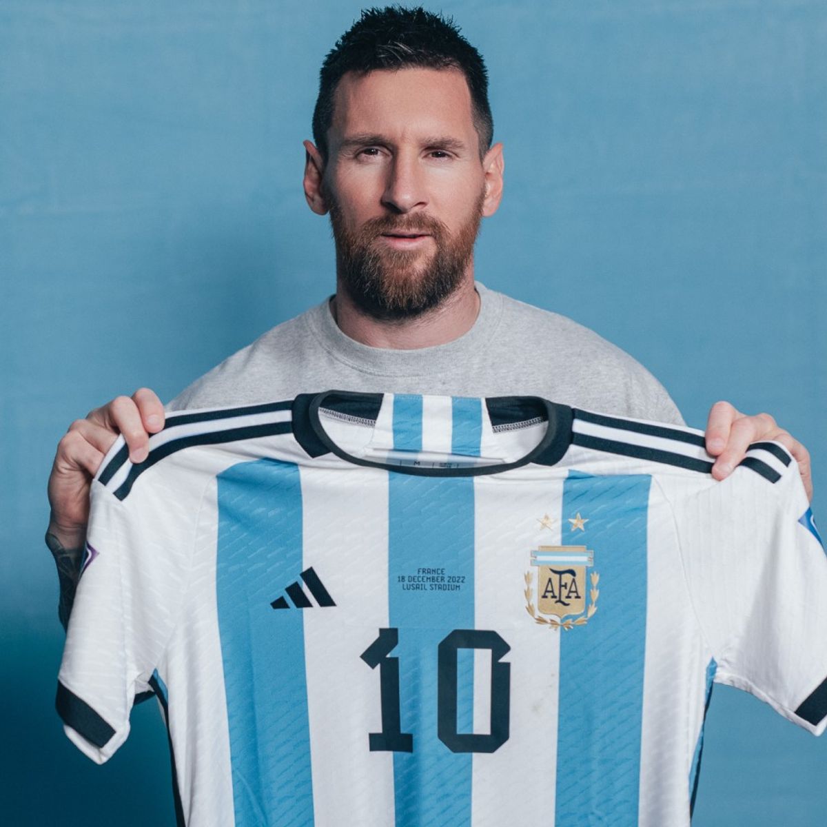 Lionel Messi holds his Argentina 10 shirt which is to be sold at auction in New York