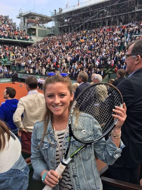 Abby Doherty holds the Head tennis racquet thrown into the crowd by a victorious Novak Djokovic at the 2016 French Open tennis final.