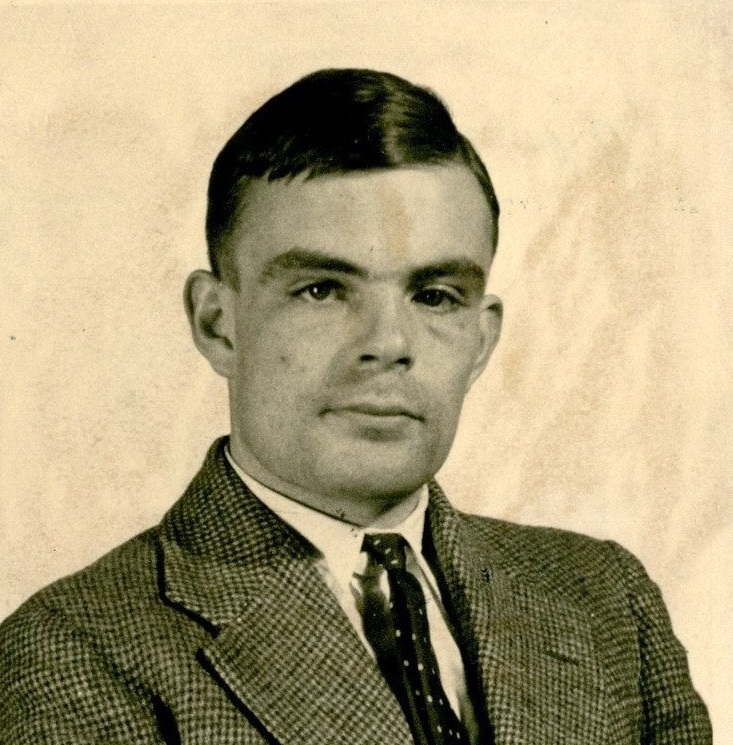 A portrait photograph of Alan Turing in shirt, tie, and suit jacket, taken in 1936 at Princeton University, USA.