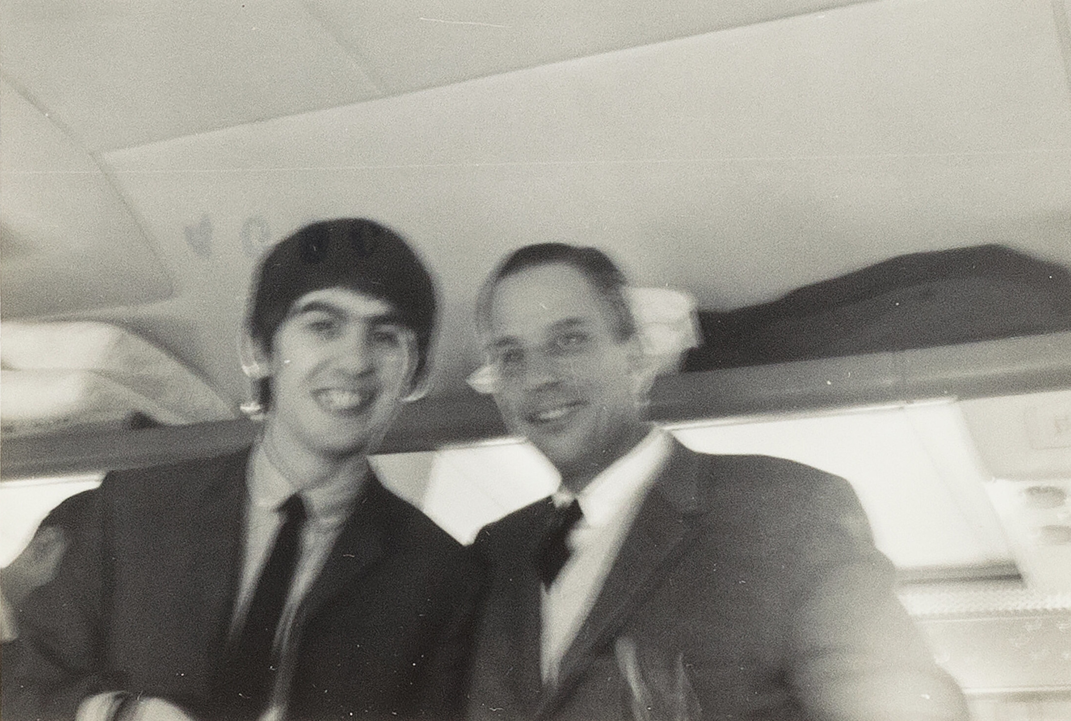 George Harrison of The Beatles with George Harrison, newspaper reporter, aboard a flight to New York in February 1964.
