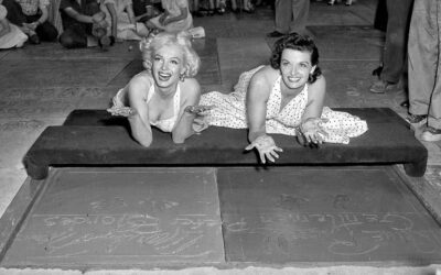 Marilyn Monroe and Jane Russell leave hand and footprints in the Hollywood Walk of Fame.