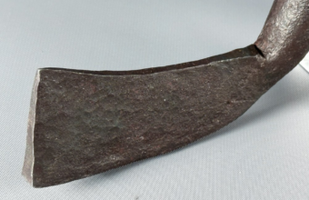 the iron blade of what is claimed to be the world's oldest golf club is shown in close up with maker's marks easily visible in the metal.