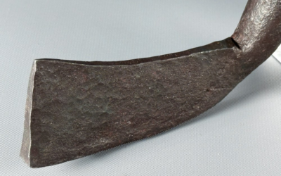 the iron blade of what is claimed to be the world's oldest golf club is shown in close up with maker's marks easily visible in the metal.