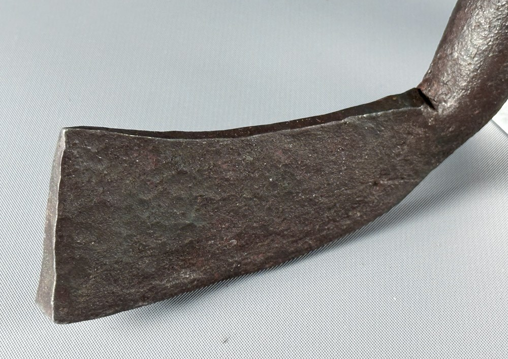 the iron blade of what is claimed to be the world's oldest golf club is shown in close up with maker's marks easily visible in the metal.