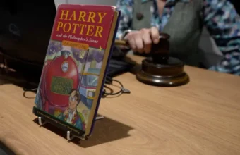 Harry Potter and the Philosopher's Stone Book propped on table