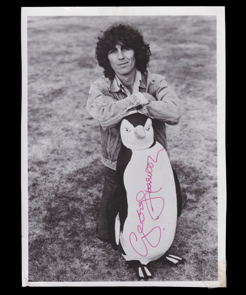 George Harrison signed photograph with penguin ornament from 1976