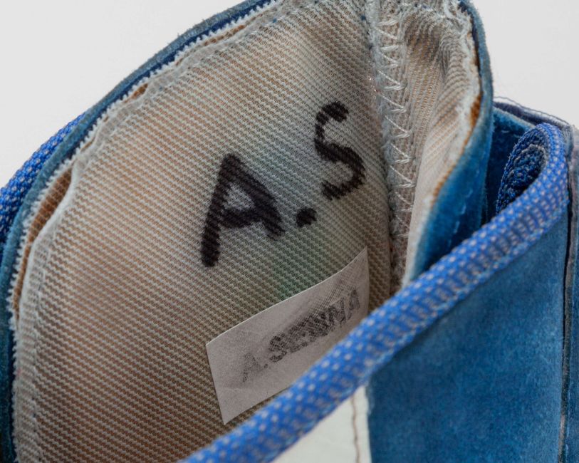 interior of blue Adidas F1 boots showing AS initials in pen and Ayrton Senna label. 