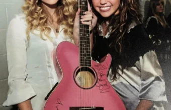 Taylor Swift and Miley Cyrus with a pink accoustic guitar they have both signed at the Staples Center in Los Angeles before the 2009 Grammy Awards.