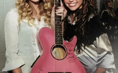 Taylor Swift and Miley Cyrus with a pink accoustic guitar they have both signed at the Staples Center in Los Angeles before the 2009 Grammy Awards.