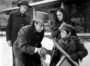 Still from Citizen Kane showing young Charles Foster Kane with Rosebud his sled and Thatcher, his guardian and banker.