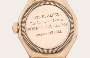 rear of case of Mercedez Gleitzer's "companion" or "vindication" watch, a 1928 Rolex Oyster with dedication to the cross Channel swimmer.
