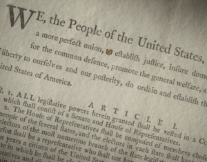 Opening lines of the Constitution of the United States of America shown in an original draft copy of the document used by Rufus King.