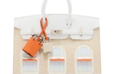 A pink handbag styled to look like the front of a house