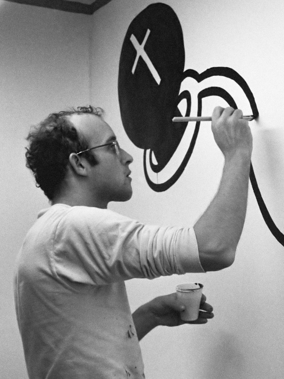 Keith Haring painting a mural, Stedelijk Museum, 1986