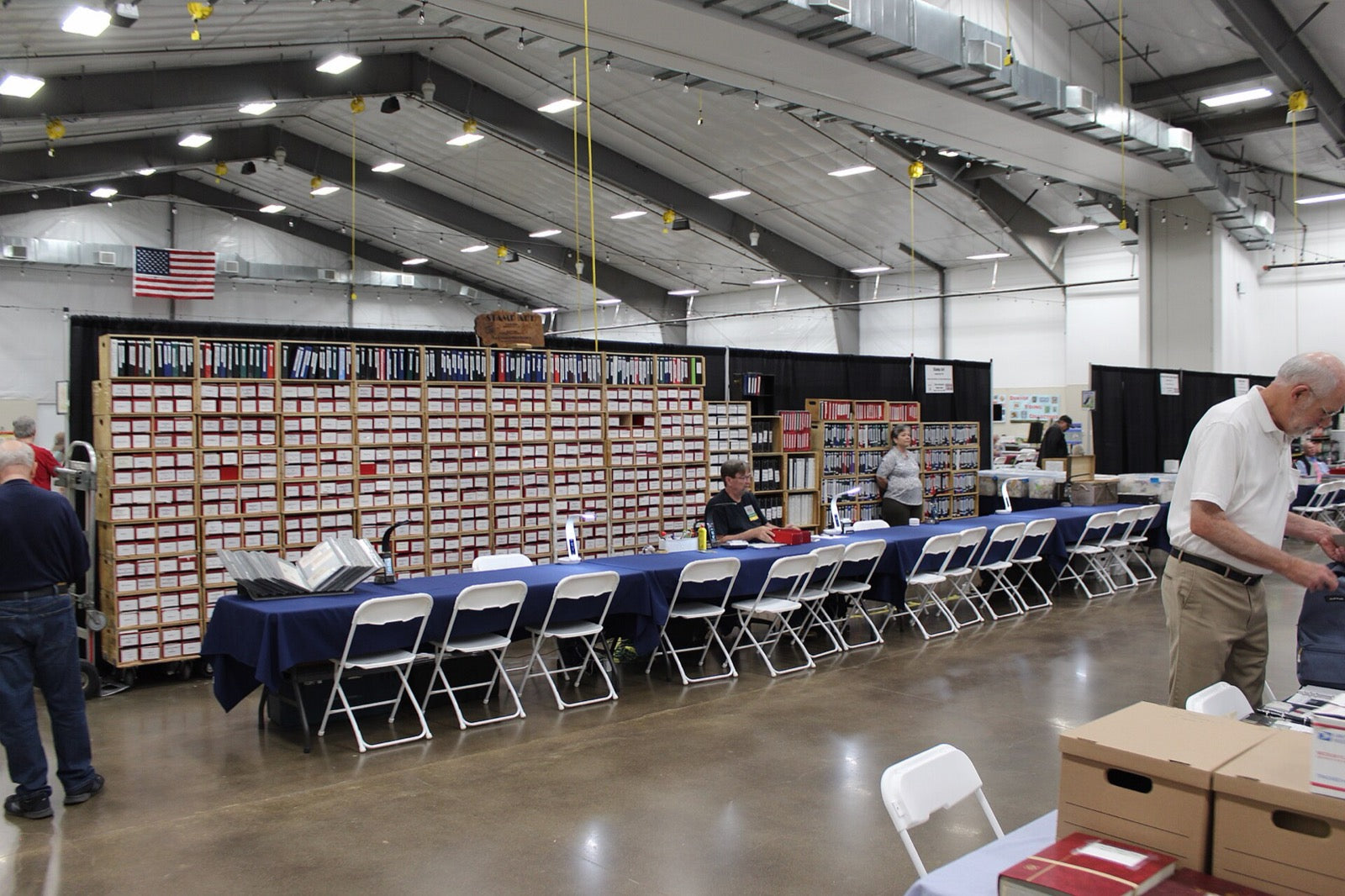 Stock boxes and dealer tables at a stamp show