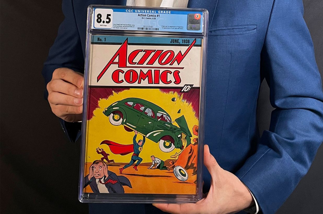 A person holds a graded copy of Action Comics 1
