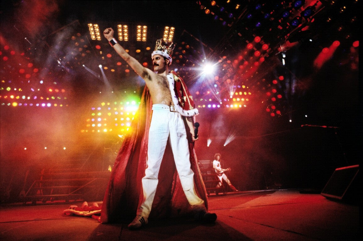 Freddie Mercury and Queen performing on stage at Wembley Stadium during the 1986 Magic Tour