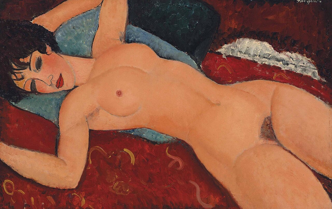 A woman reclines nude across the canvas in Modigliani's signature elongated style, her skin painted in warm ochres against a dark red ground. The directness of the pose was considered provocative when his nudes were first exhibited in Paris in 1917.