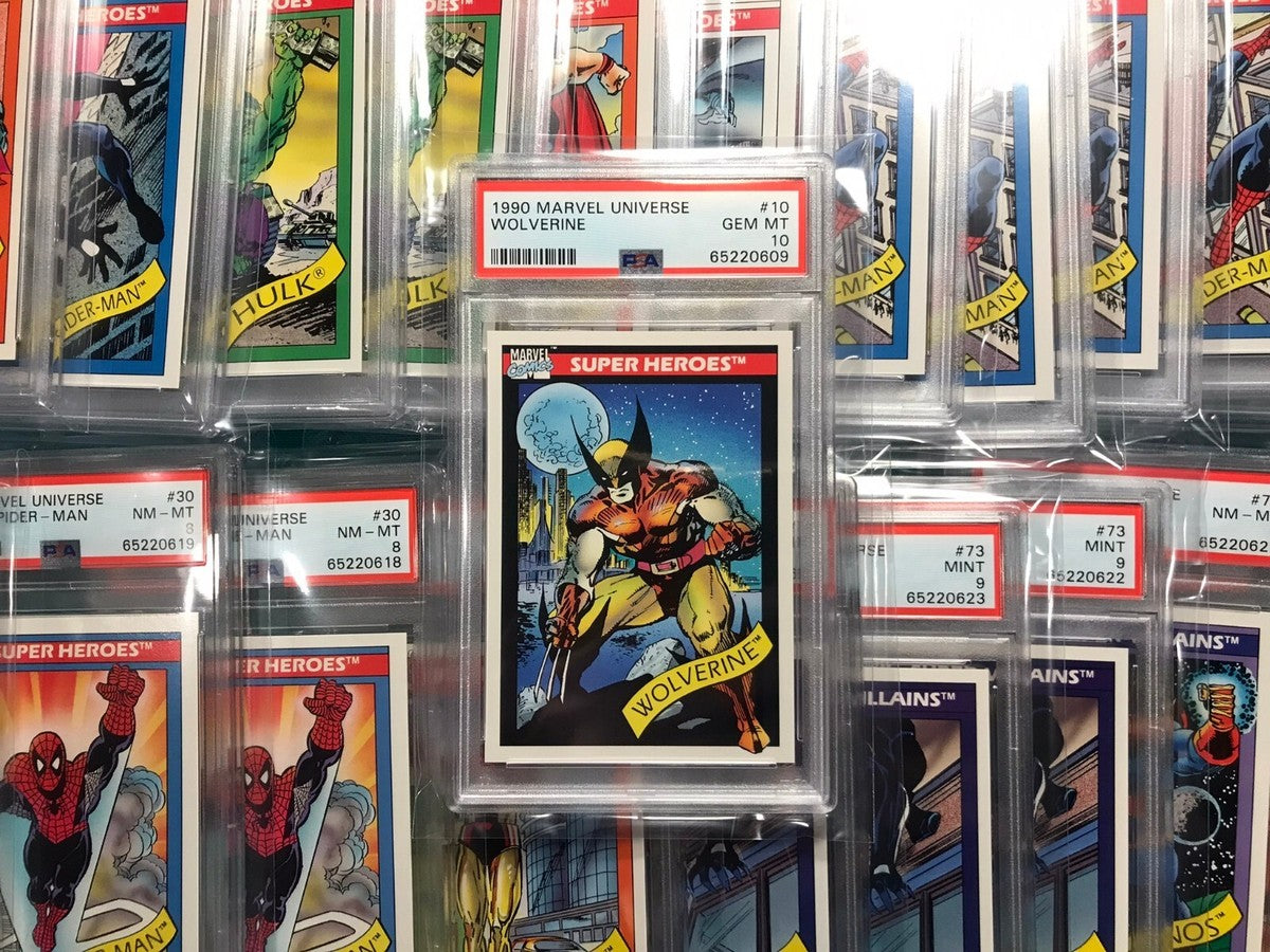 PSA-graded 1990s Marvel trading cards arranged in a display case, showing hologram and foil variants