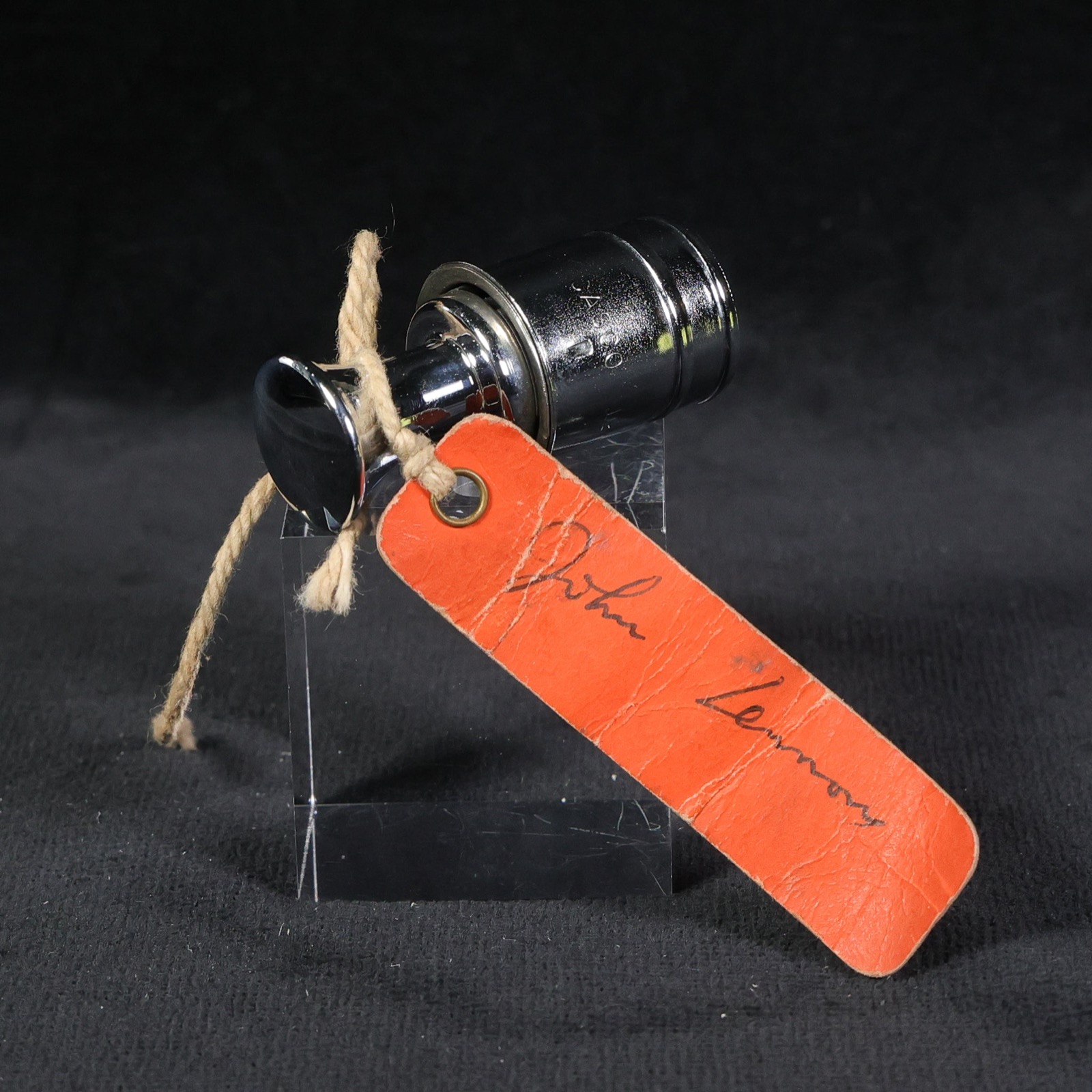 Cigar lighter from John Lennon's white Rolls-Royce, with its signed tag